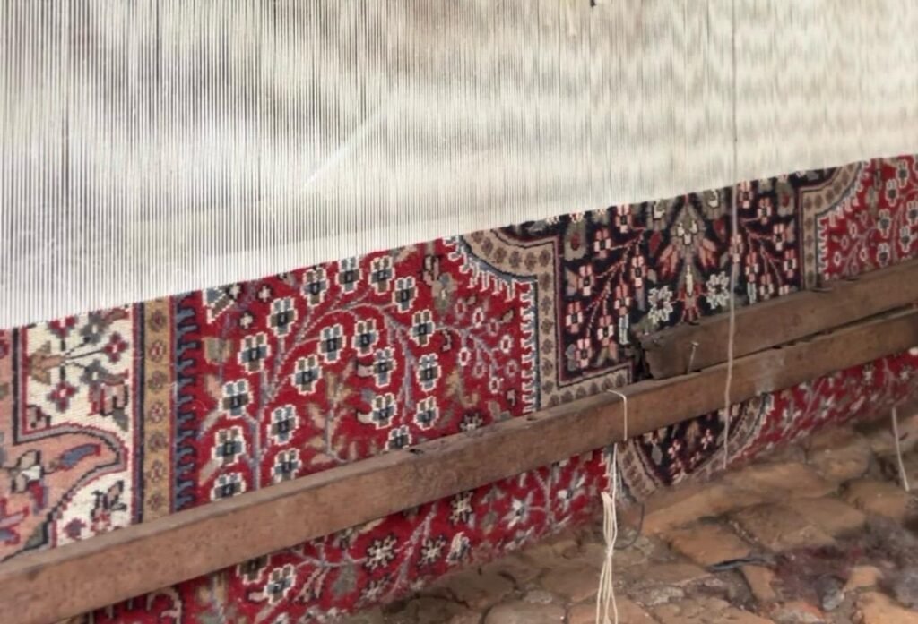 Hand knotted indo persian rug in weaving process