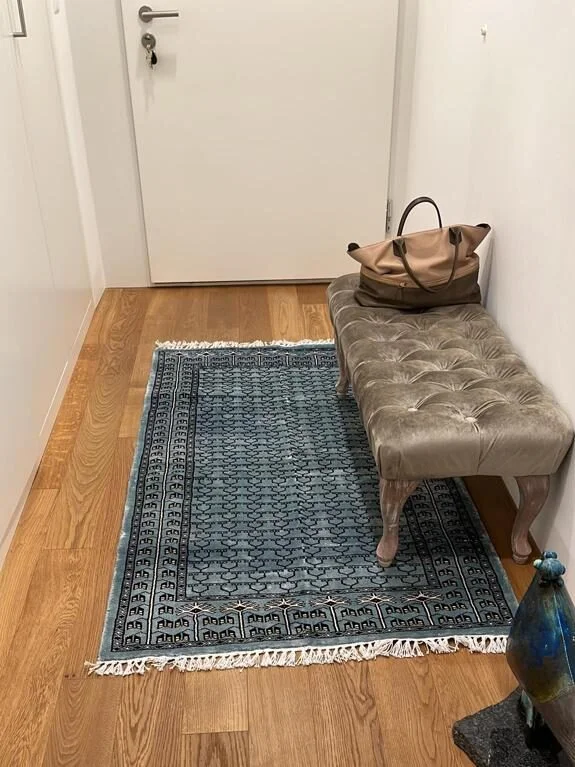 Amma Carpets handmade rug green in entryway